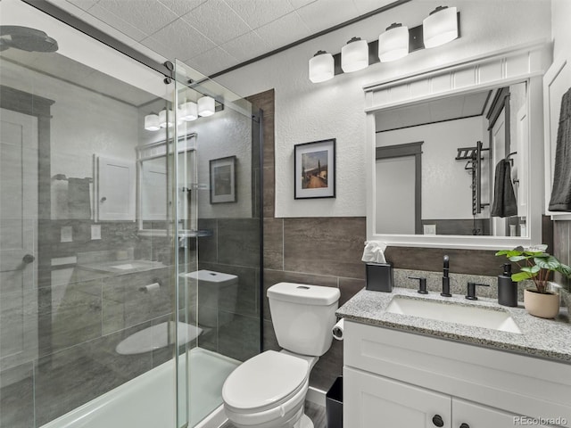 19726 Applewood Ct, Parker, CO 80138 - bathroom featuring vanity, a stall shower, and tile walls