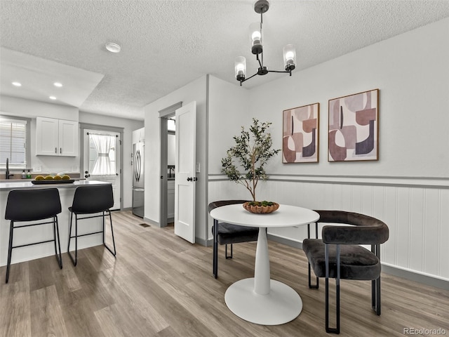 19726 Applewood Ct, Parker, CO 80138 - dining space with a textured ceiling, a chandelier, light wood-style flooring, and recessed lighting