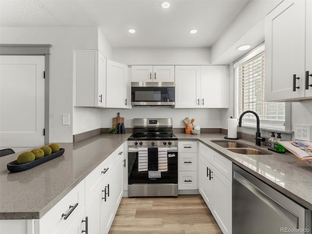19726 Applewood Ct, Parker, CO 80138 - kitchen featuring stainless steel appliances, white cabinetry, light wood finished floors, light stone countertops, and recessed lighting