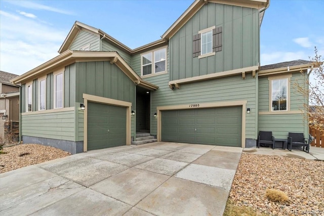 17880 W 94th Dr, Arvada, CO 80007 - view of front of house featuring board and batten siding, driveway, and an attached garage