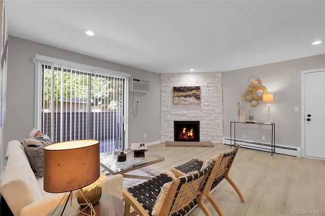 10150 Virginia Ave Unit 103, Denver, CO 80247 - living area with baseboard heating, light wood finished floors, a wall mounted air conditioner, a fireplace, and recessed lighting