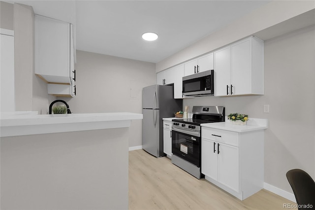 10150 Virginia Ave Unit 103, Denver, CO 80247 - kitchen with stainless steel appliances, light wood-style flooring, light countertops, and white cabinetry