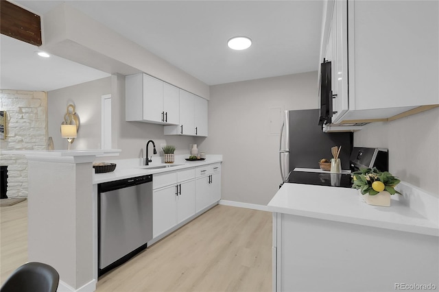 10150 Virginia Ave Unit 103, Denver, CO 80247 - kitchen featuring stainless steel dishwasher, light wood finished floors, range, light countertops, and white cabinetry