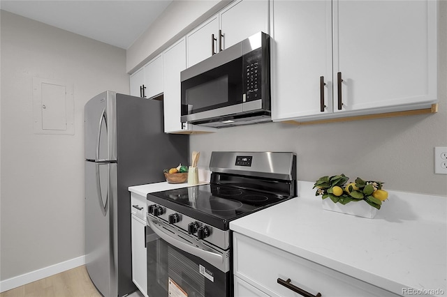 10150 Virginia Ave Unit 103, Denver, CO 80247 - kitchen with appliances with stainless steel finishes, electric panel, white cabinets, and light countertops