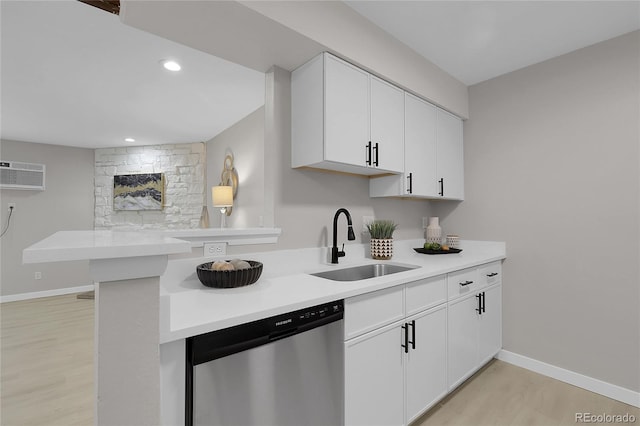 10150 Virginia Ave Unit 103, Denver, CO 80247 - kitchen featuring stainless steel dishwasher, light wood-type flooring, light countertops, white cabinetry, and recessed lighting