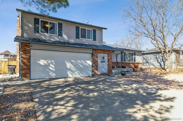 view of front of house featuring a garage, concrete driveway, brick siding, and fence