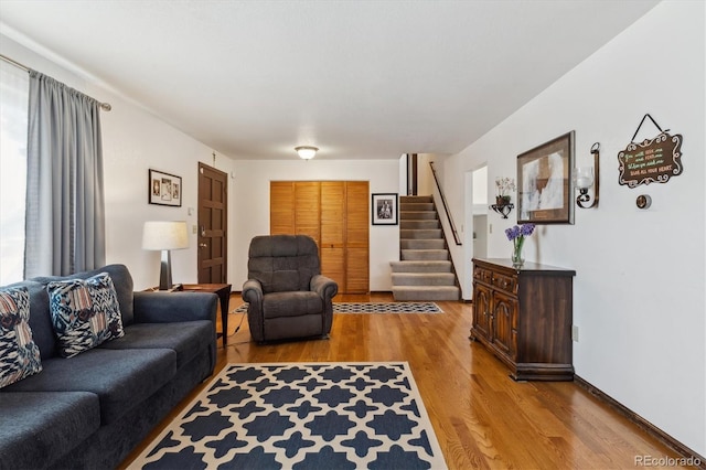 living room featuring stairs and wood finished floors