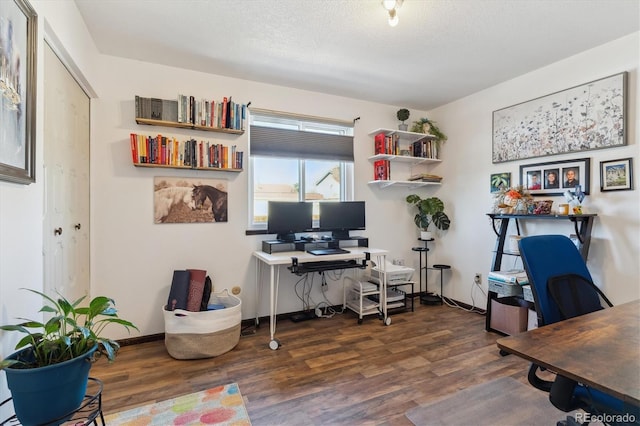 office with a textured ceiling, wood finished floors, and baseboards