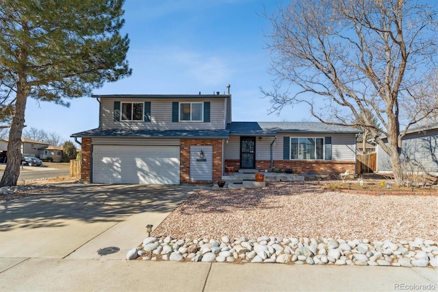 view of front facade featuring a garage, driveway, and brick siding