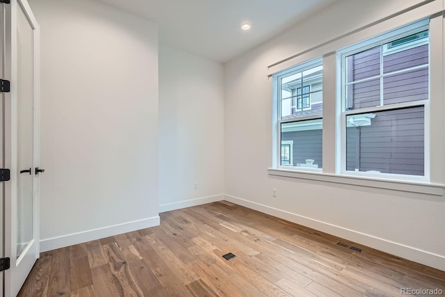 unfurnished room featuring light hardwood / wood-style flooring