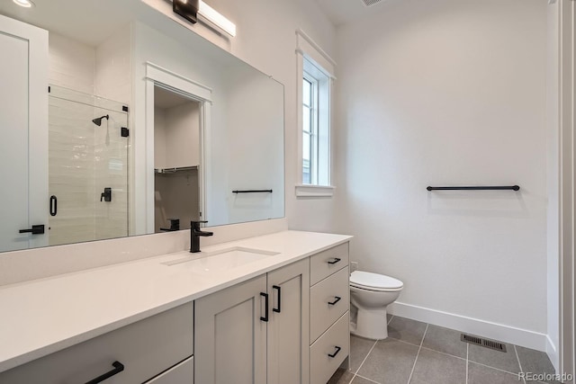 bathroom with toilet, an enclosed shower, vanity, and tile patterned flooring