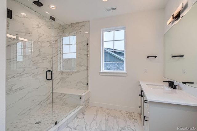 bathroom with a shower with door and vanity