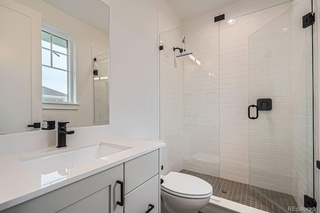 bathroom with toilet, an enclosed shower, and vanity