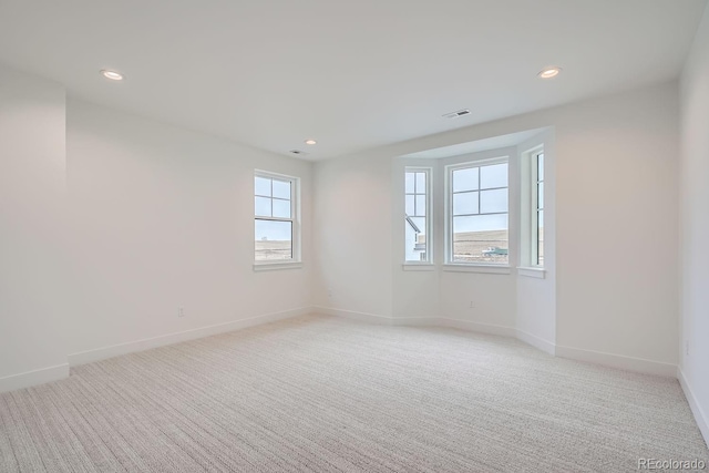 carpeted empty room with a wealth of natural light