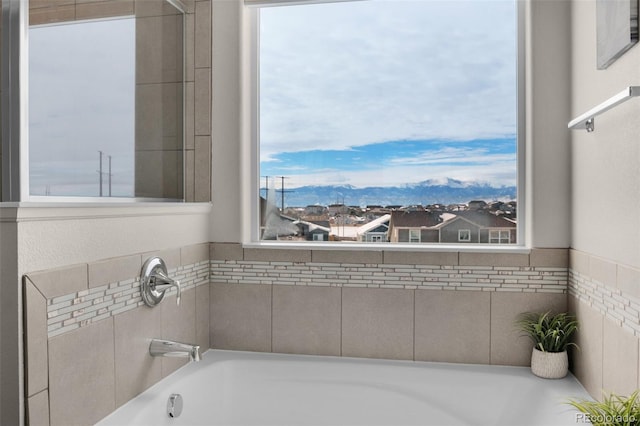 bathroom with a tub to relax in