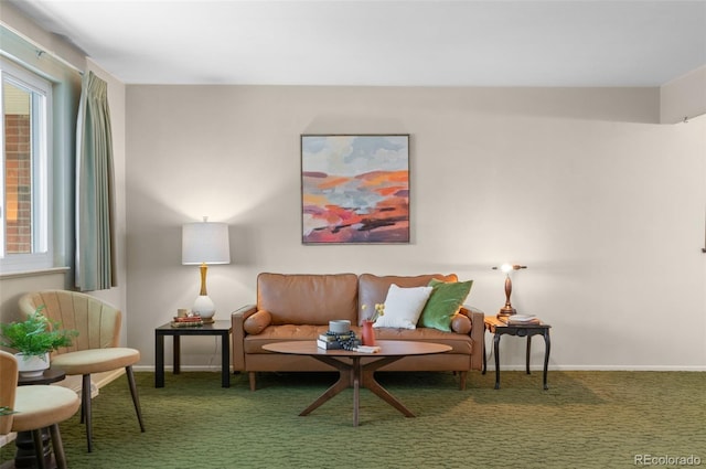 sitting room featuring carpet floors and baseboards