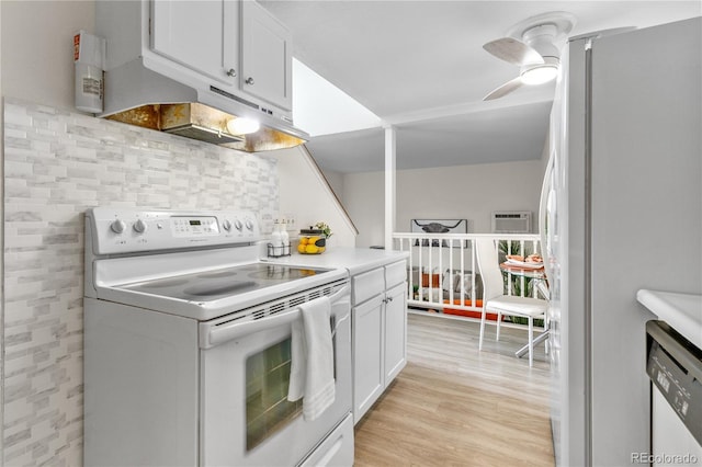 kitchen featuring under cabinet range hood, light wood-type flooring, white appliances, and white cabinets