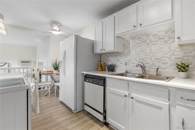 kitchen featuring a sink, tasteful backsplash, stove, and white dishwasher