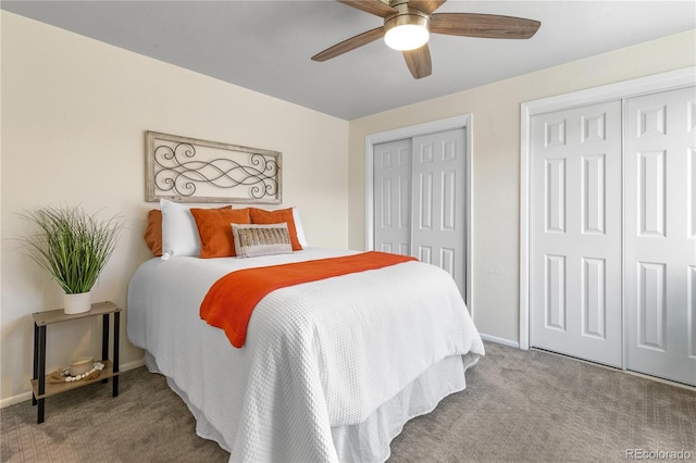 carpeted bedroom featuring baseboards, multiple closets, and a ceiling fan