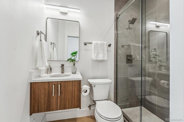 bathroom with walk in shower, vanity, and toilet