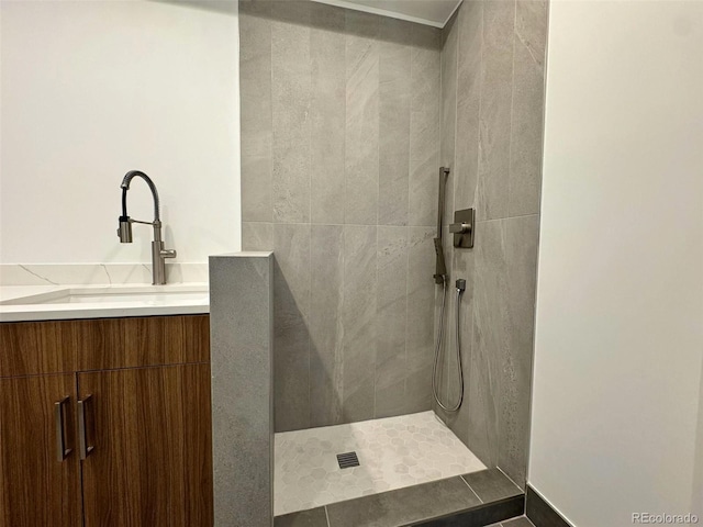 bathroom with vanity and tiled shower