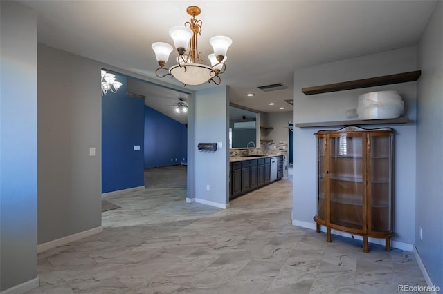 kitchen featuring marble finish floor, open shelves, light countertops, visible vents, and a sink