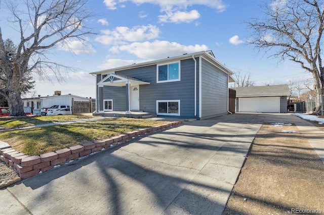 view of front of house with a front lawn, a garage, and an outdoor structure