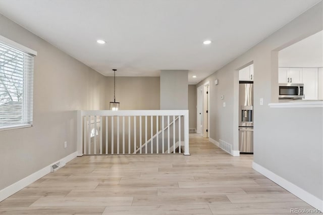 hall with light hardwood / wood-style flooring