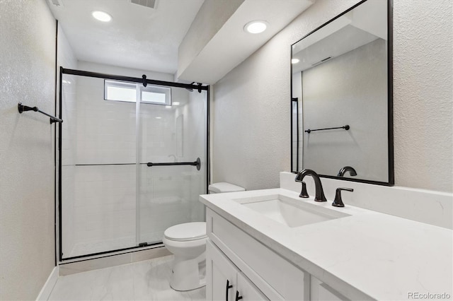 bathroom featuring toilet, a shower with door, and vanity