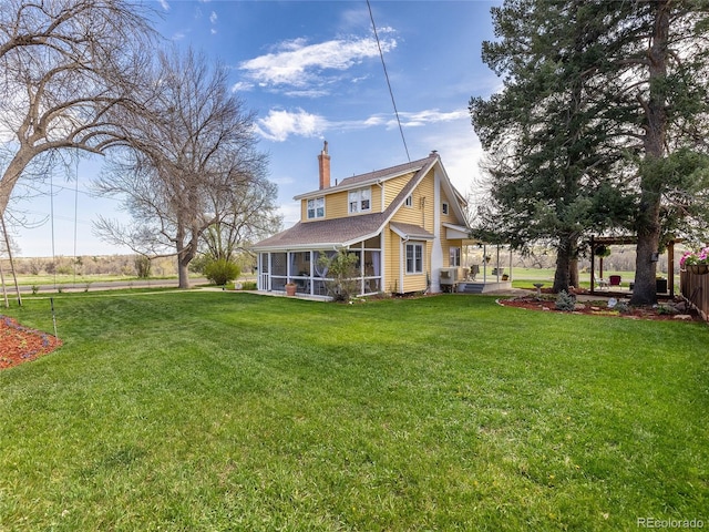 7835 Valley View St, Louviers, CO 80131 - back of property with a chimney, a sunroom, and a shingled roof