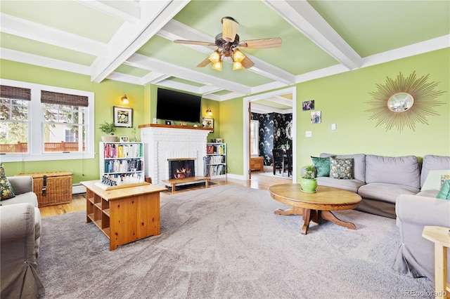 7835 Valley View St, Louviers, CO 80131 - living area featuring coffered ceiling, a fireplace, beamed ceiling, a ceiling fan, and wood finished floors