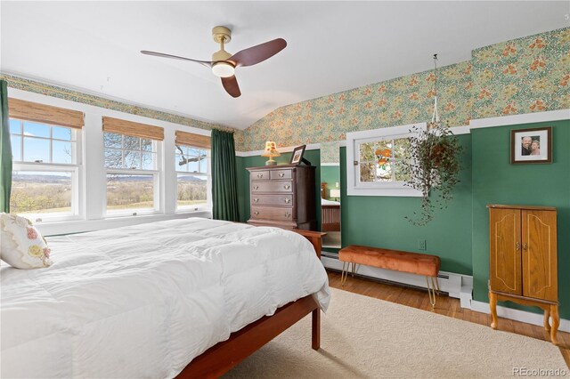 7835 Valley View St, Louviers, CO 80131 - bedroom with wallpapered walls, wood finished floors, a ceiling fan, baseboards, and vaulted ceiling
