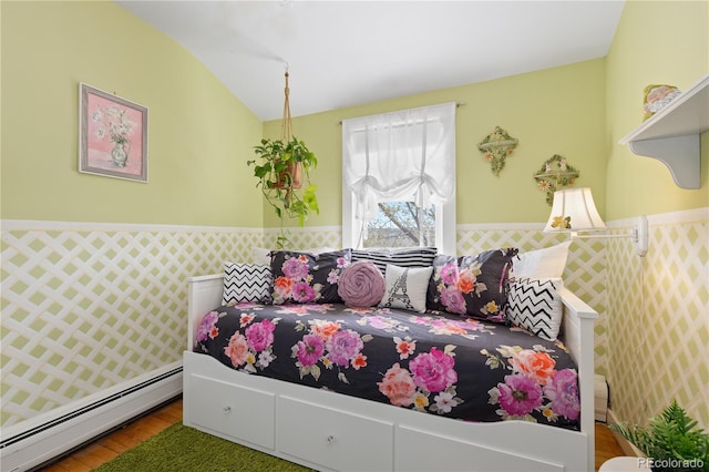 7835 Valley View St, Louviers, CO 80131 - bedroom featuring baseboard heating, wood finished floors, and a wainscoted wall