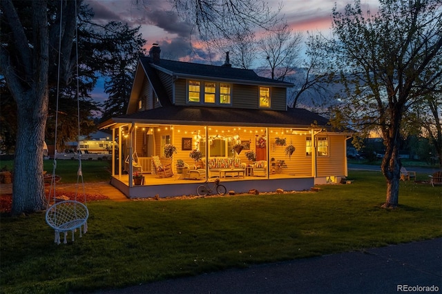 7835 Valley View St, Louviers, CO 80131 - view of front of house with a porch, a chimney, and a yard