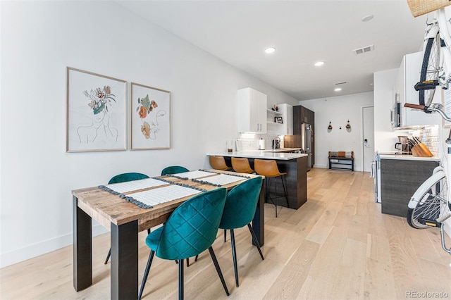 dining space featuring light hardwood / wood-style flooring