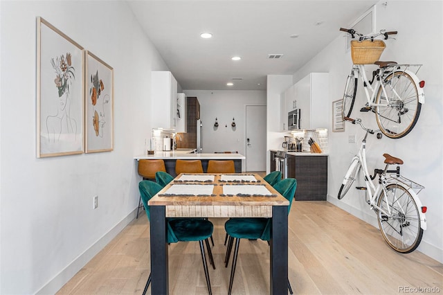 dining area featuring light wood-type flooring