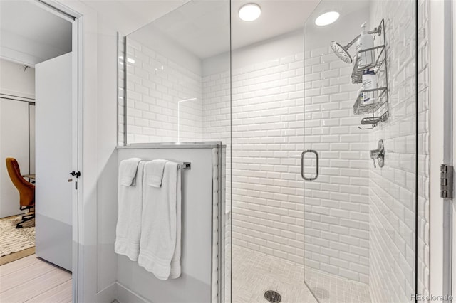 bathroom featuring a shower with shower door