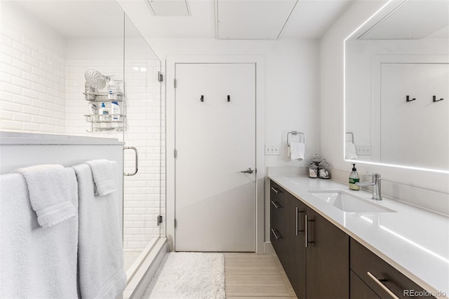 bathroom with an enclosed shower and vanity