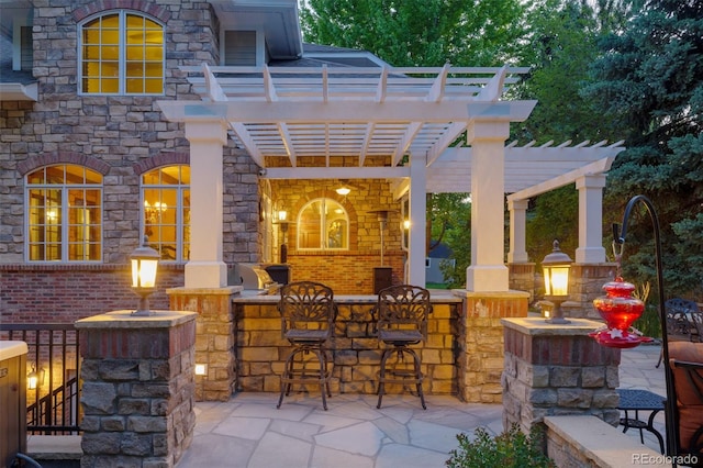 view of patio / terrace with outdoor dry bar and a pergola