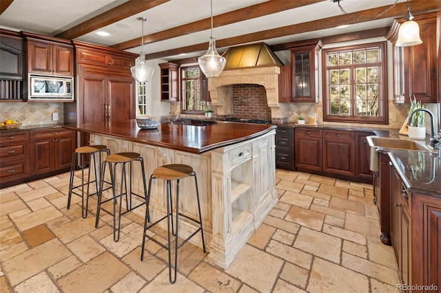 kitchen featuring stainless steel appliances, stone tile flooring, a kitchen island, and open shelves