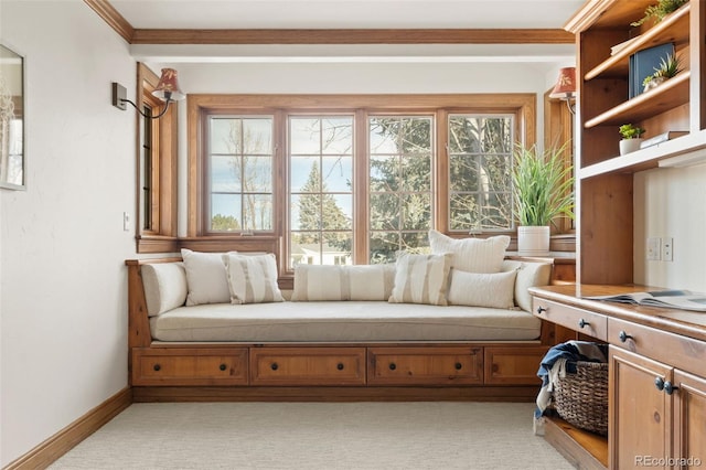 sitting room featuring crown molding, light carpet, baseboards, and a healthy amount of sunlight