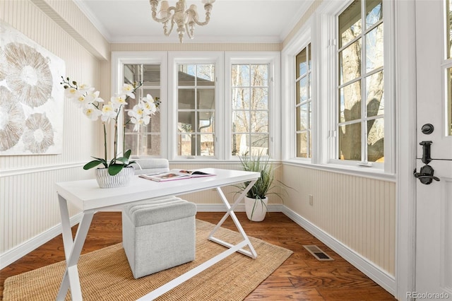 sunroom / solarium with a notable chandelier, visible vents, and a wealth of natural light