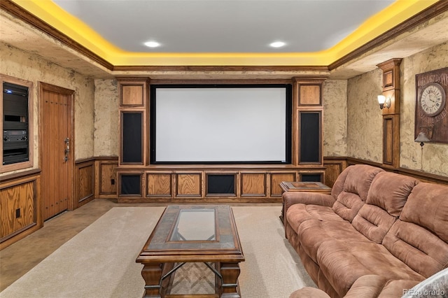 home theater room featuring a tray ceiling, a wainscoted wall, and recessed lighting