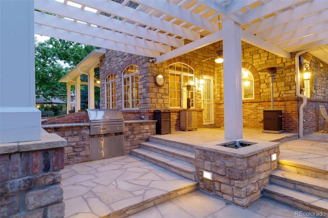 view of patio / terrace with a fire pit, exterior kitchen, area for grilling, and a pergola