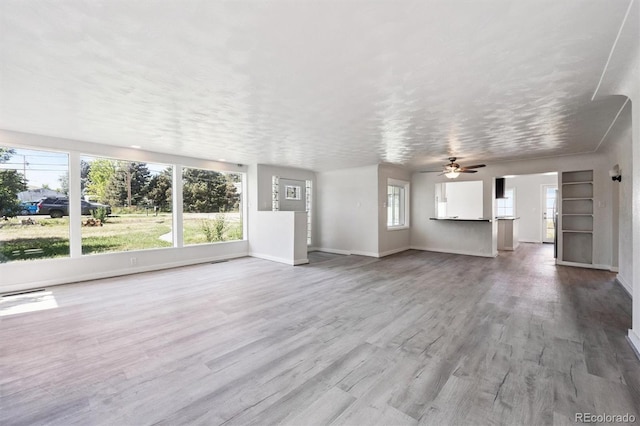 16707 W 10th Ave, Golden, CO 80401 - unfurnished living room with ceiling fan and wood finished floors
