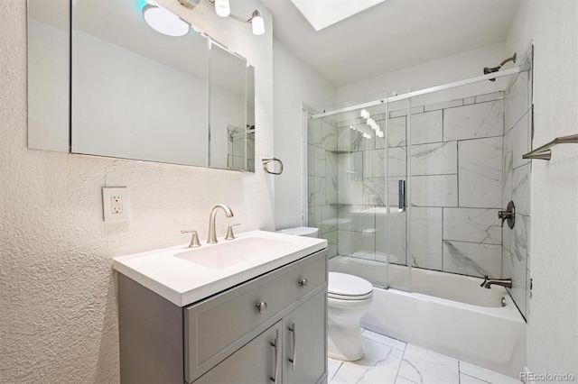 16707 W 10th Ave, Golden, CO 80401 - bathroom with marble finish floors, vanity, a skylight, a textured wall, and combined bath / shower with glass door