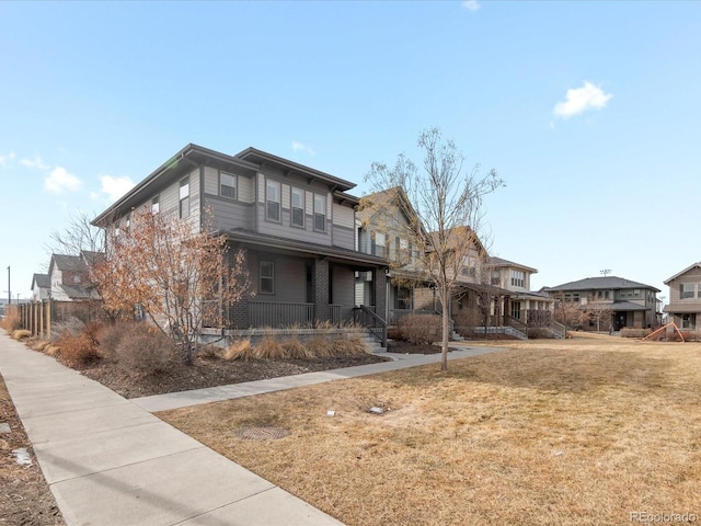 view of front facade with covered porch and a front lawn