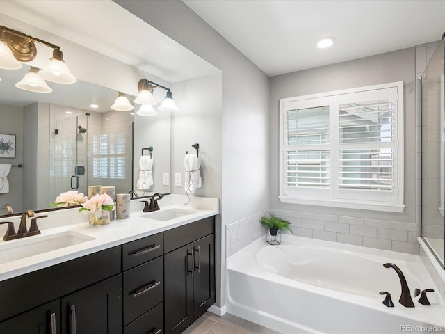 bathroom with independent shower and bath, vanity, and tile patterned flooring