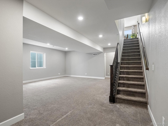 basement featuring a healthy amount of sunlight and carpet