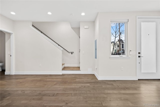 foyer entrance with hardwood / wood-style flooring and electric panel